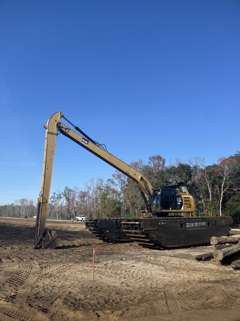A Cat long reach excavator on a job site